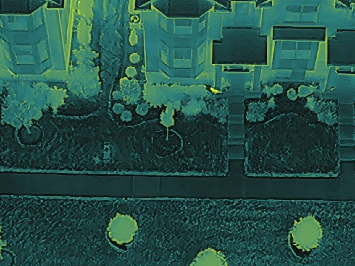 Thermal drone view of the same yards. Warm objects stand out clearly against the cool ground.